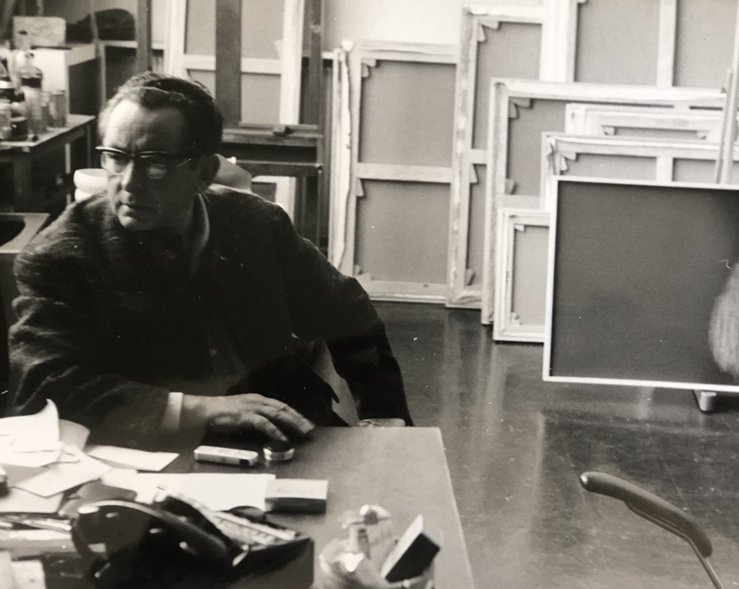 Hans HARTUNG - The artist sitting in his studio, in front of his canvases.